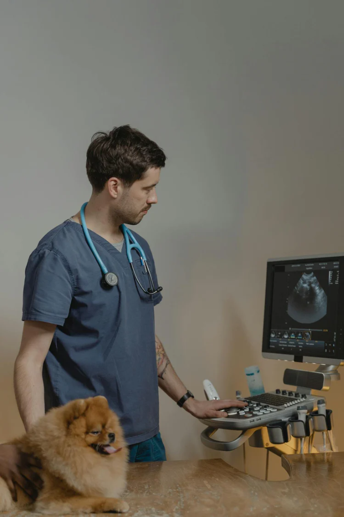 Veterinary professional reading their printed reference book with a tablet PDF beside it